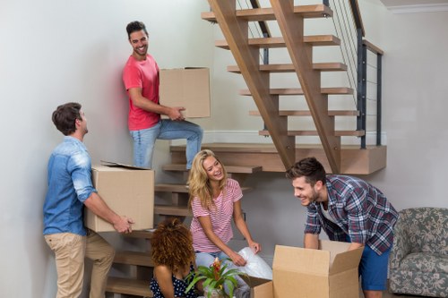 Professional movers packing a living room